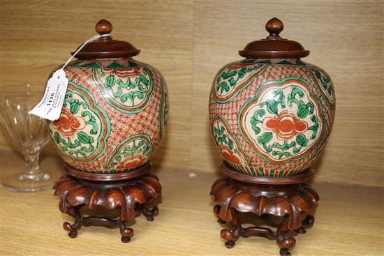 A pair of 19th century Chinese enamelled porcelain jars with wood covers and stands height 25cm